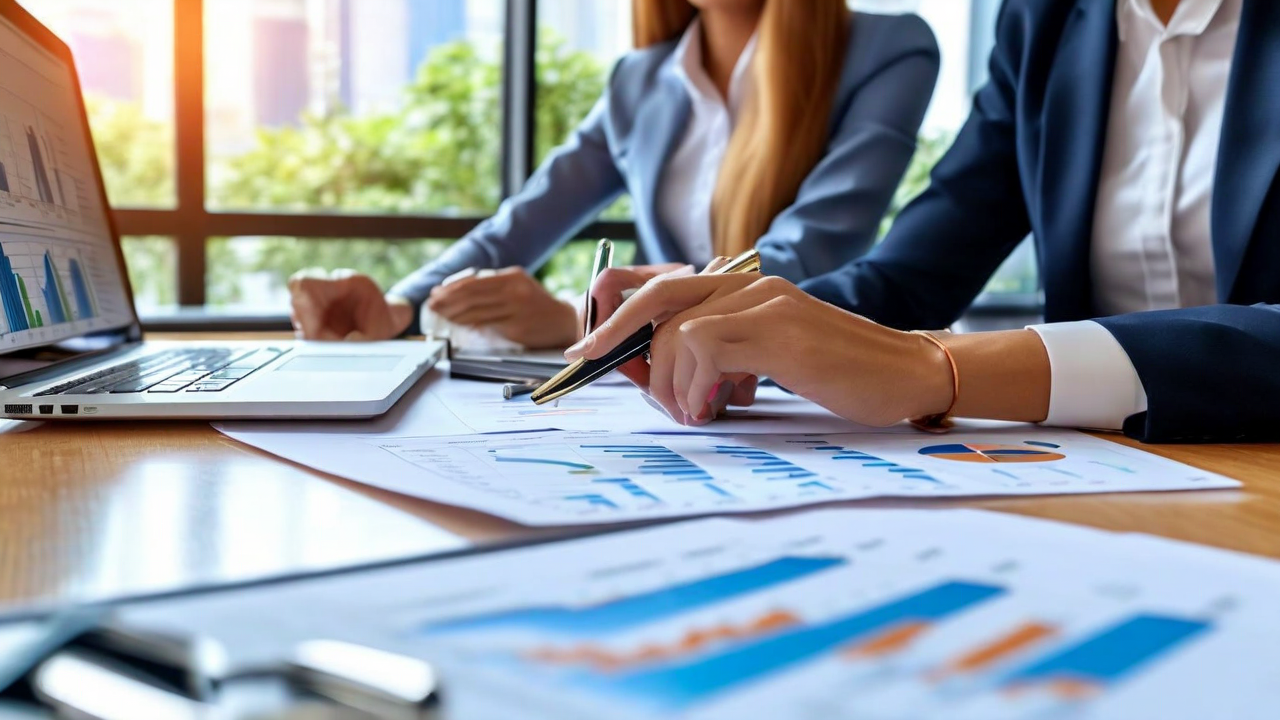 Article header image —  Finance team reviewing travel savings dashboard